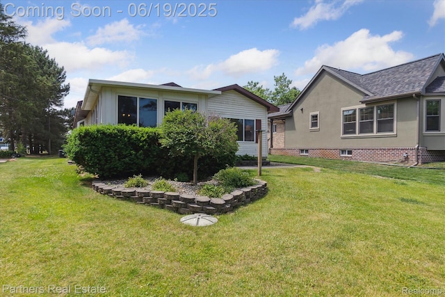8331 Hilton Rd, Brighton, MI 48114 - back of house with a lawn