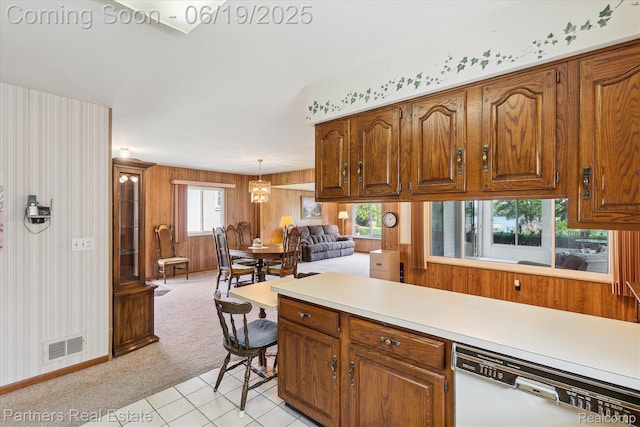 8331 Hilton Rd, Brighton, MI 48114 - kitchen featuring dishwasher, light countertops, and brown cabinetry