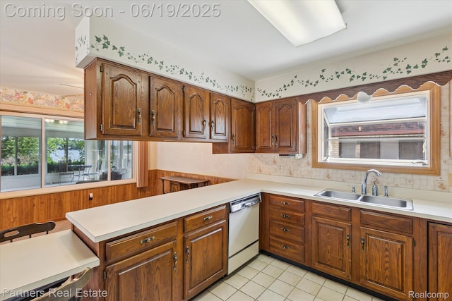 8331 Hilton Rd, Brighton, MI 48114 - kitchen featuring dishwasher, light countertops, light tile patterned floors, a peninsula, and backsplash