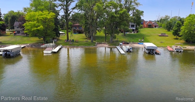 8331 Hilton Rd, Brighton, MI 48114 - dock area with a water view and a lawn