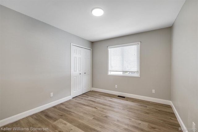 1545 W 9 Mile Rd, Ferndale, MI 48220 - unfurnished bedroom with wood finished floors and a closet