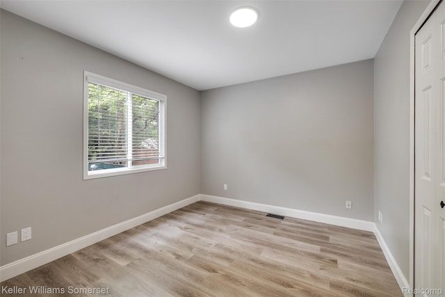1545 W 9 Mile Rd, Ferndale, MI 48220 - spare room featuring light wood-style flooring and baseboards