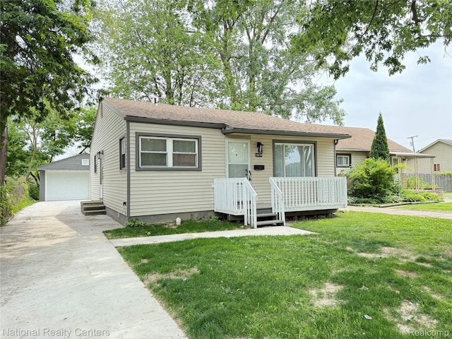 23074 Bolam Ave, Warren, MI 48089 - view of front facade with an outdoor structure, a front yard, a detached garage, and roof with shingles