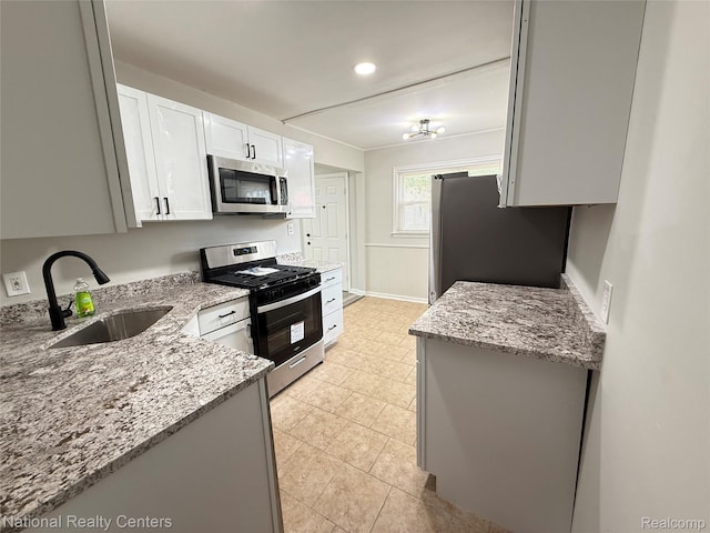 23074 Bolam Ave, Warren, MI 48089 - kitchen featuring appliances with stainless steel finishes, light stone countertops, white cabinets, light tile patterned floors, and recessed lighting