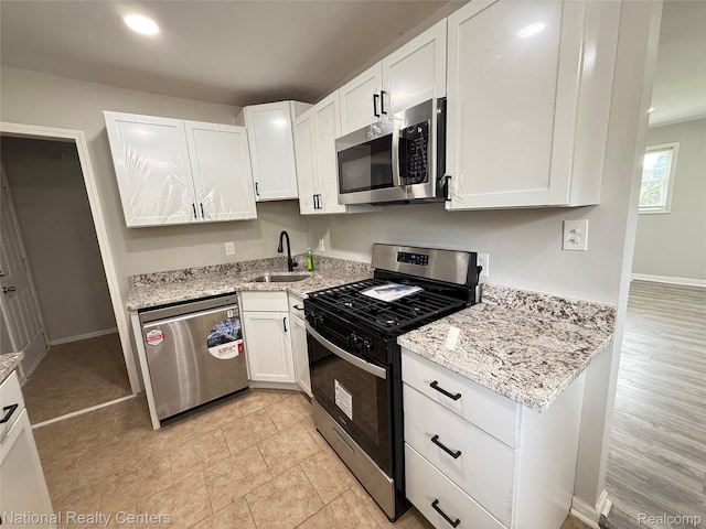 23074 Bolam Ave, Warren, MI 48089 - kitchen with appliances with stainless steel finishes, white cabinetry, light stone countertops, and recessed lighting