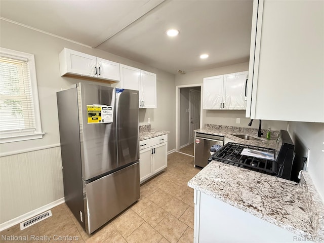 23074 Bolam Ave, Warren, MI 48089 - kitchen with appliances with stainless steel finishes, white cabinetry, light stone counters, wainscoting, and recessed lighting
