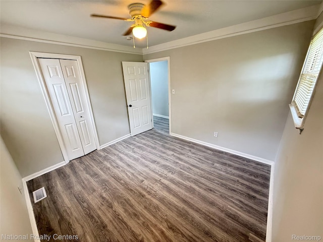 23074 Bolam Ave, Warren, MI 48089 - unfurnished bedroom with dark wood-type flooring, a closet, ornamental molding, and ceiling fan