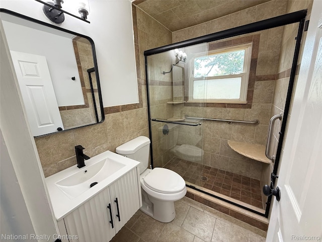 23074 Bolam Ave, Warren, MI 48089 - full bathroom featuring vanity, tile walls, a stall shower, a wainscoted wall, and tile patterned flooring