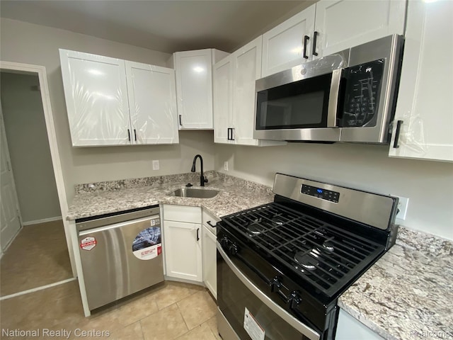 23074 Bolam Ave, Warren, MI 48089 - kitchen with stainless steel appliances, white cabinets, light tile patterned floors, and light stone counters