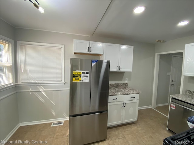 23074 Bolam Ave, Warren, MI 48089 - kitchen featuring appliances with stainless steel finishes, white cabinets, light stone countertops, and recessed lighting