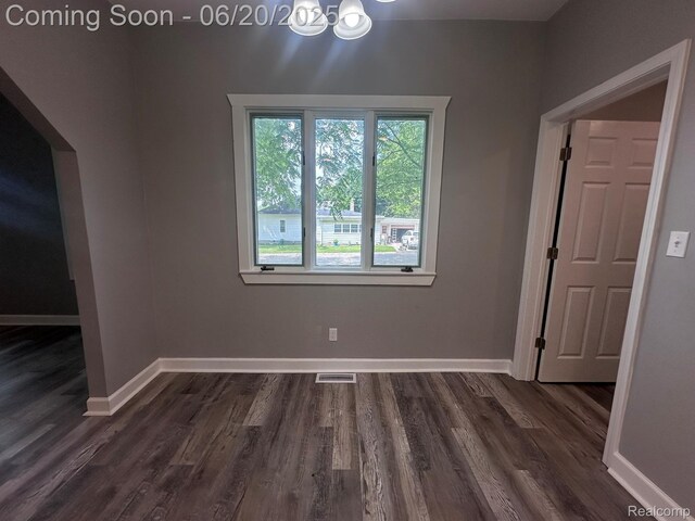 101 Morrell St, Yale, MI 48097 - unfurnished dining area featuring a chandelier and dark wood-type flooring