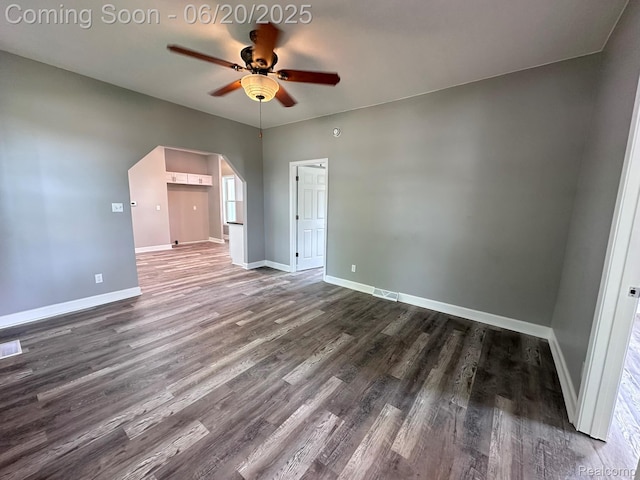 101 Morrell St, Yale, MI 48097 - empty room featuring ceiling fan, dark wood-type flooring, and arched walkways