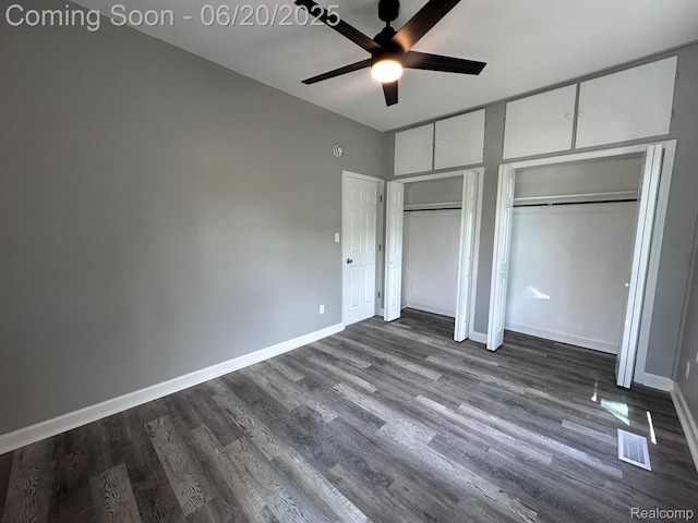 101 Morrell St, Yale, MI 48097 - unfurnished bedroom with two closets, dark wood-type flooring, and a ceiling fan
