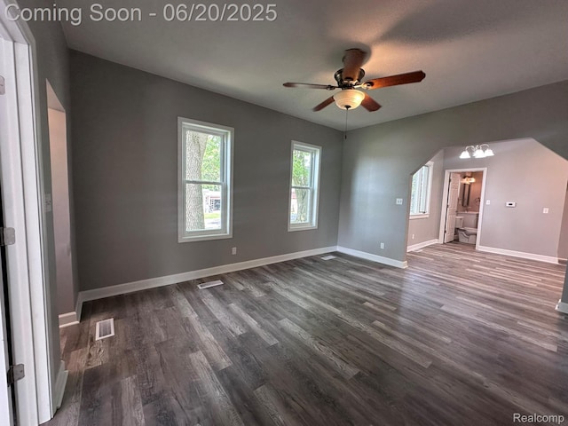 101 Morrell St, Yale, MI 48097 - spare room with arched walkways, dark wood-type flooring, and ceiling fan