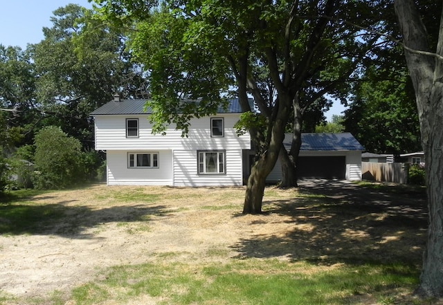 26370 S Shore Dr, Mendon, MI 49072 - back of house with driveway, a metal roof, and a chimney