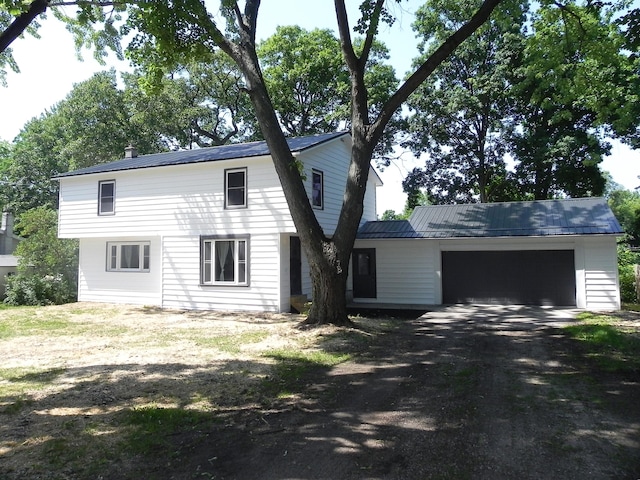 26370 S Shore Dr, Mendon, MI 49072 - view of front of house with driveway, an attached garage, a metal roof, and a chimney