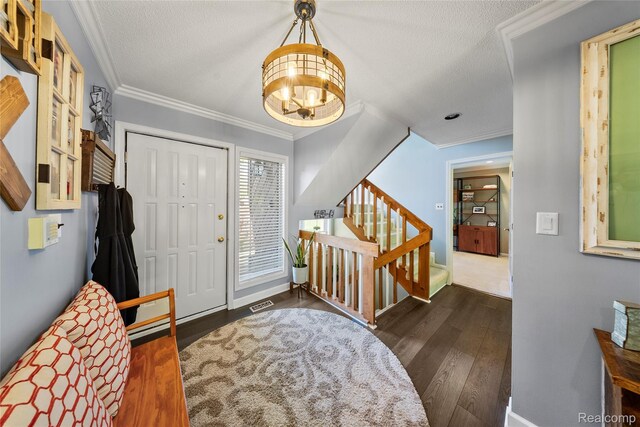 8206 Saint James Ct, Grosse Ile, MI 48138 - entrance foyer with dark wood-style floors, a chandelier, crown molding, stairs, and a textured ceiling