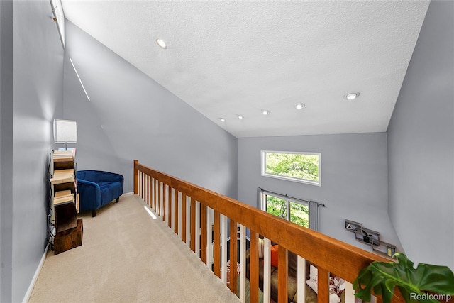 8206 Saint James Ct, Grosse Ile, MI 48138 - hallway featuring lofted ceiling, carpet floors, an upstairs landing, a textured ceiling, and recessed lighting