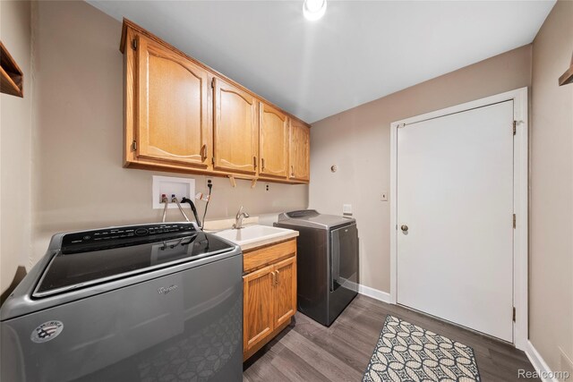 8206 Saint James Ct, Grosse Ile, MI 48138 - laundry area featuring cabinet space, washing machine and clothes dryer, and wood finished floors