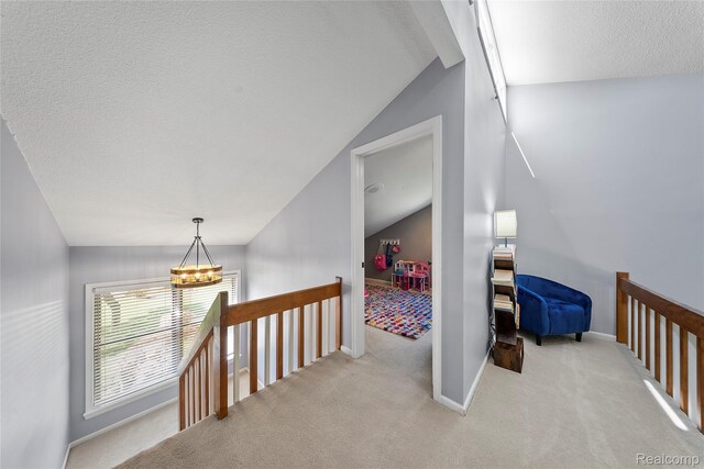 8206 Saint James Ct, Grosse Ile, MI 48138 - hallway featuring lofted ceiling, carpet, a chandelier, and a textured ceiling