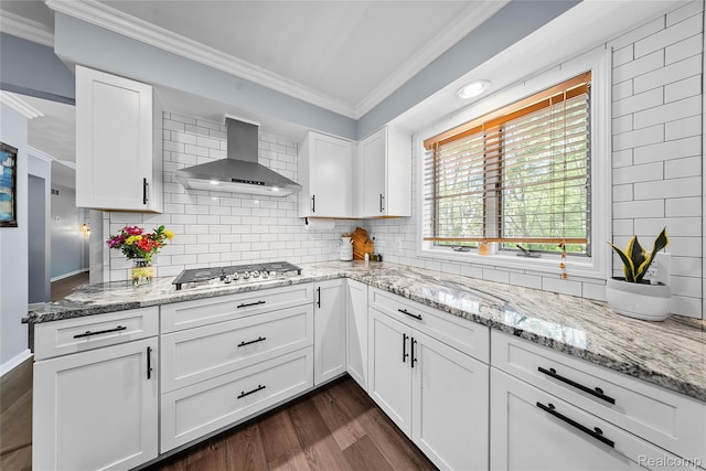 8206 Saint James Ct, Grosse Ile, MI 48138 - kitchen with wall chimney range hood, crown molding, dark wood-type flooring, stainless steel gas stovetop, and white cabinets