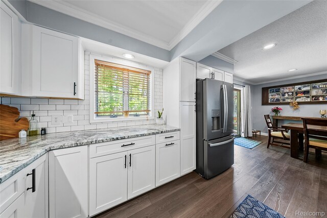8206 Saint James Ct, Grosse Ile, MI 48138 - kitchen with stainless steel fridge with ice dispenser, crown molding, dark wood-style floors, decorative backsplash, and white cabinets