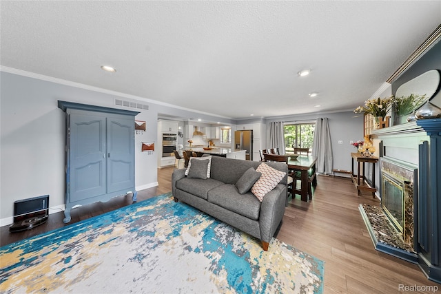 8206 Saint James Ct, Grosse Ile, MI 48138 - living room with a fireplace, crown molding, wood finished floors, and recessed lighting