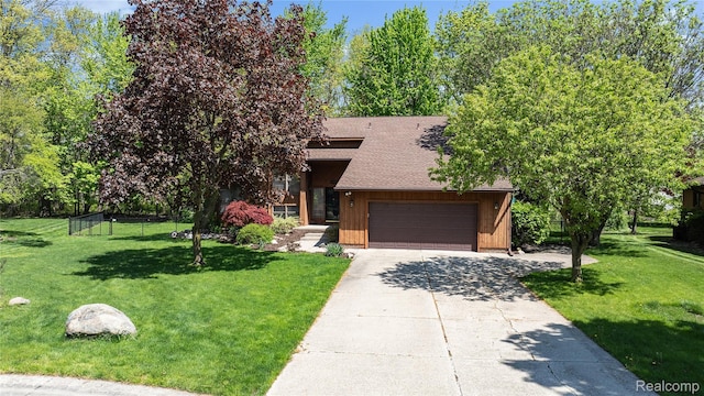 8206 Saint James Ct, Grosse Ile, MI 48138 - view of front facade with concrete driveway, a garage, and a shingled roof
