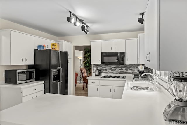 2896 Chippewa Ct, Troy, MI 48085 - kitchen with black appliances, light countertops, white cabinets, tasteful backsplash, and track lighting