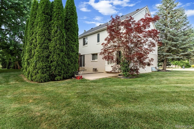 2896 Chippewa Ct, Troy, MI 48085 - back of house featuring a patio, a lawn, stucco siding, and brick siding