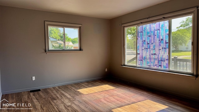713 Wiltshire Dr, Owosso, MI 48867 - spare room featuring wood finished floors and baseboards