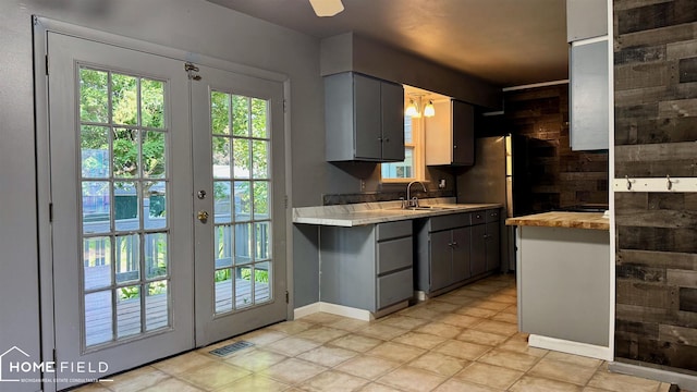 713 Wiltshire Dr, Owosso, MI 48867 - kitchen featuring plenty of natural light, gray cabinetry, and french doors