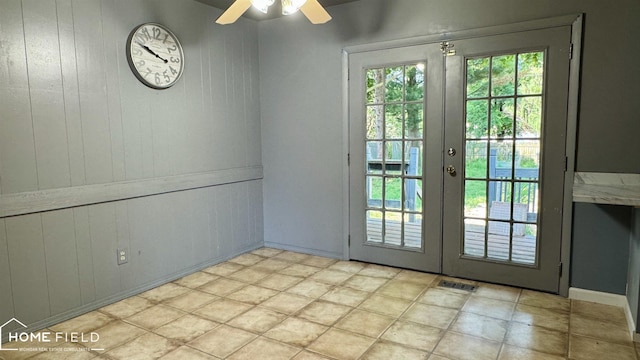713 Wiltshire Dr, Owosso, MI 48867 - doorway to outside with french doors, wooden walls, and a ceiling fan