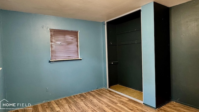 713 Wiltshire Dr, Owosso, MI 48867 - unfurnished bedroom with wood finished floors and a closet
