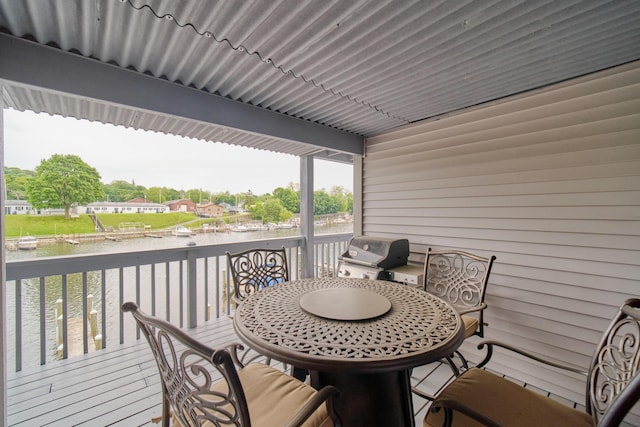 317 5th Ave Unit 8, Manistee, MI 49660 - wooden deck with a water view, a grill, and outdoor dining space