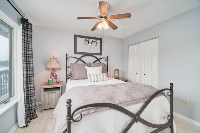 317 5th Ave Unit 8, Manistee, MI 49660 - bedroom featuring light wood-style flooring, a closet, and ceiling fan