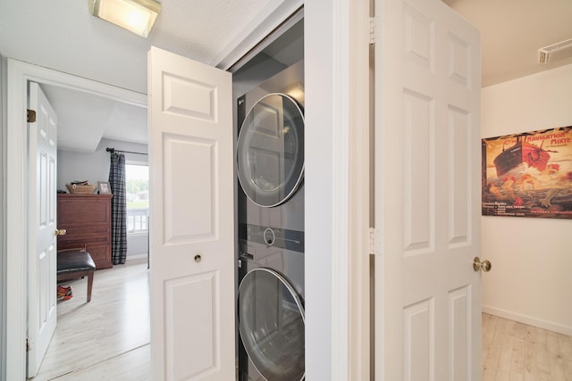 317 5th Ave Unit 8, Manistee, MI 49660 - laundry area with estacked washer and dryer and light wood-type flooring
