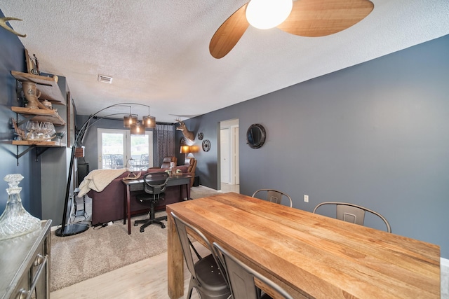 317 5th Ave Unit 8, Manistee, MI 49660 - dining area with a ceiling fan, a desk, a textured ceiling, and light wood-style flooring