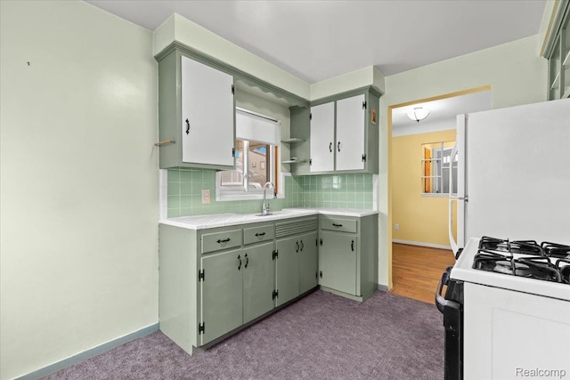 24845 Petersburg Ave, Eastpointe, MI 48021 - kitchen featuring carpet flooring, black range with gas stovetop, freestanding refrigerator, and tasteful backsplash