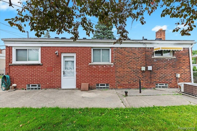 24845 Petersburg Ave, Eastpointe, MI 48021 - back of house with a chimney, brick siding, and a patio area