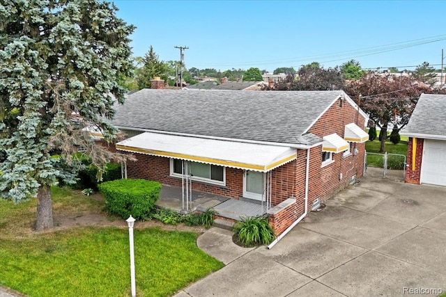 24845 Petersburg Ave, Eastpointe, MI 48021 - view of front of home with a shingled roof, brick siding, a chimney, driveway, and a garage