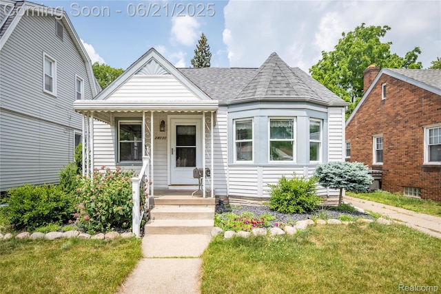 24130 Penn St, Dearborn, MI 48124 - view of front of home with a shingled roof and a front yard