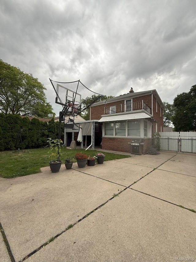 2130 Geneva St, Dearborn, MI 48124 - view of front of property with brick siding, a chimney, a balcony, and a gate