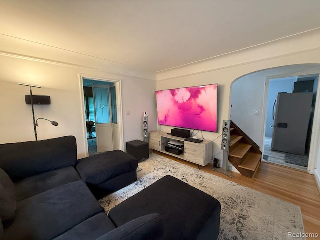 2130 Geneva St, Dearborn, MI 48124 - living room featuring wood finished floors, stairs, and arched walkways
