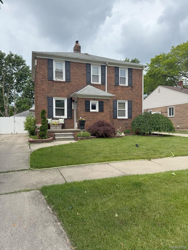 2130 Geneva St, Dearborn, MI 48124 - view of front of property with brick siding, a chimney, and a gate