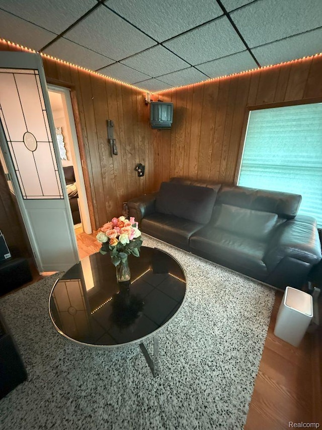 2130 Geneva St, Dearborn, MI 48124 - living room featuring wood walls and a paneled ceiling