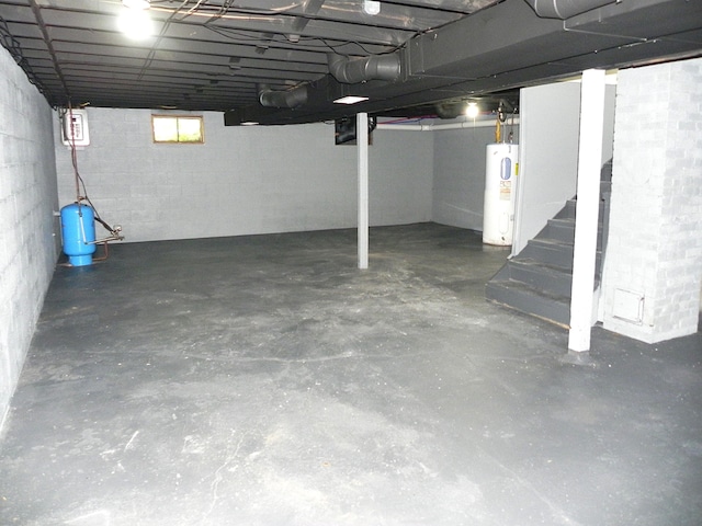 27869 M-60, Mendon, MI 49072 - basement featuring water heater, a water pressure tank, concrete block wall, and stairway