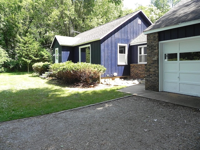 27869 M-60, Mendon, MI 49072 - view of property exterior featuring a shingled roof, a garage, board and batten siding, driveway, and a lawn