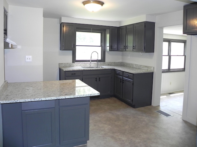 27869 M-60, Mendon, MI 49072 - kitchen with plenty of natural light, a peninsula, light stone counters, and carpet floors