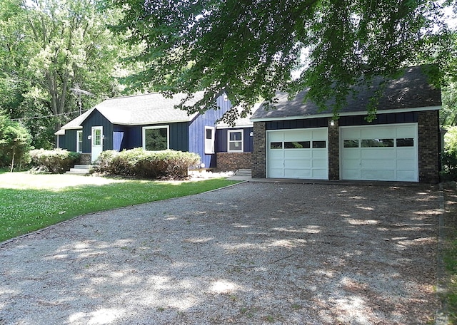 27869 M-60, Mendon, MI 49072 - view of front of property featuring brick siding, gravel driveway, a garage, and roof with shingles